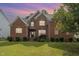 Charming two-story brick home with well-kept lawn and landscaping at 1003 Red Sunset Dr, Apex, NC 27502