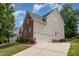 Spacious two-car garage with extended driveway and partial brick exterior at 1003 Red Sunset Dr, Apex, NC 27502