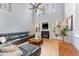 Bright living room with built-in shelving around the fireplace and large windows at 1003 Red Sunset Dr, Apex, NC 27502