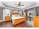 Bright main bedroom with a ceiling fan, hardwood floors, and large windows at 1003 Red Sunset Dr, Apex, NC 27502