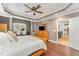An expansive main bedroom featuring tray ceiling, hardwood floors, an ensuite bathroom, and lots of closet space at 1003 Red Sunset Dr, Apex, NC 27502