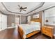 Spacious main bedroom with tray ceilings, a ceiling fan, and an ensuite bathroom at 1003 Red Sunset Dr, Apex, NC 27502