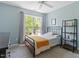 Cozy bedroom features natural light from a window and a black metal bookshelf at 1007 Grandover Dr, Durham, NC 27713