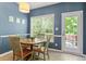 Dining area with large windows, a modern light fixture, and a door to the outside at 1007 Grandover Dr, Durham, NC 27713