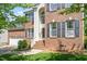 Close-up view of a brick home entrance with steps, white railings, and dark shutters at 1007 Grandover Dr, Durham, NC 27713