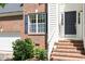 Detailed shot of the front steps with the house number, dark door, and brick facade at 1007 Grandover Dr, Durham, NC 27713