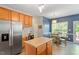 Kitchen area with a center island, stainless steel appliances, and a connected dining area at 1007 Grandover Dr, Durham, NC 27713
