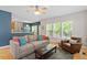 Well-lit living room featuring a fireplace, neutral walls, and hardwood floors at 1007 Grandover Dr, Durham, NC 27713