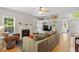 Living room with a fireplace, built-in shelves, hardwood floors, and natural light at 1007 Grandover Dr, Durham, NC 27713