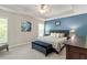 Comfortable primary bedroom with neutral colors, a ceiling fan, and carpeted flooring at 1007 Grandover Dr, Durham, NC 27713
