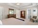 Spacious main bedroom features a tray ceiling, sitting area and large dresser and mirror at 1007 Grandover Dr, Durham, NC 27713