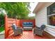 Charming outdoor lounge area on a red painted deck with a blue cushioned furniture set at 102 Fairgrove Way Way, Cary, NC 27511