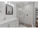 Bright bathroom featuring a marble tiled shower with glass door and pebble flooring at 102 Fairgrove Way Way, Cary, NC 27511
