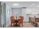 Charming dining area adjacent to the kitchen, featuring wood table, chairs and laminate flooring at 102 Fairgrove Way Way, Cary, NC 27511