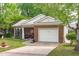 Charming brick home with attached garage, well-maintained lawn, and landscaped yard at 102 Fairgrove Way Way, Cary, NC 27511