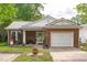 Charming single story brick home with manicured lawn and attached one car garage at 102 Fairgrove Way Way, Cary, NC 27511