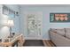 Light-filled foyer featuring laminate flooring, stylish console table and light blue walls at 102 Fairgrove Way Way, Cary, NC 27511