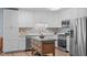 Well-equipped kitchen with white cabinets, stainless steel appliances and kitchen island at 102 Fairgrove Way Way, Cary, NC 27511