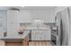 Bright kitchen featuring white cabinets, stainless steel appliances, light countertops, and a decorative backsplash at 102 Fairgrove Way Way, Cary, NC 27511