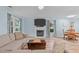 Bright living room with fireplace, TV, comfortable sofa and laminate floors throughout at 102 Fairgrove Way Way, Cary, NC 27511