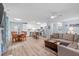 Open concept living room into kitchen and dining area with laminate flooring and large sofa at 102 Fairgrove Way Way, Cary, NC 27511