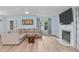 Spacious living room with a fireplace, mounted TV, large sofa and laminate flooring at 102 Fairgrove Way Way, Cary, NC 27511
