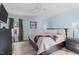 Bedroom with wood-look floors, blue walls, a ceiling fan, and dark furniture at 102 Fairgrove Way Way, Cary, NC 27511