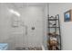The bright white tiled shower has a glass enclosure and pebble flooring at 102 Fairgrove Way Way, Cary, NC 27511