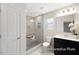 Modern bathroom featuring a tiled shower, black vanity, and a toilet at 104 S Buggy Dr # 71P, Benson, NC 27504