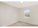 Empty bedroom featuring neutral walls, carpet, and a bright window providing natural light at 104 S Buggy Dr # 71P, Benson, NC 27504