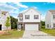 Charming two-story home featuring stone accents, white siding, and a spacious two-car garage at 104 S Buggy Dr # 71P, Benson, NC 27504