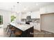 Modern kitchen with a large island featuring seating, white cabinets, and stainless steel appliances at 104 S Buggy Dr # 71P, Benson, NC 27504