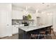 Modern kitchen with granite countertops, a large island, stainless steel appliances, and pendant lighting at 104 S Buggy Dr # 71P, Benson, NC 27504