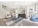 Inviting living room with contemporary furniture, a modern area rug, and staircase access at 104 S Buggy Dr # 71P, Benson, NC 27504