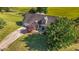 Aerial view of home with a manicured lawn, two-car garage, mature trees, and inviting curb appeal at 106 Contender Dr, Clayton, NC 27520