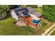 Aerial view of backyard with an above ground pool and deck, along with solar panels on the roof at 106 Contender Dr, Clayton, NC 27520