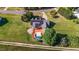 Aerial view of a home with a backyard pool, large deck, solar panels and well-maintained lawn at 106 Contender Dr, Clayton, NC 27520