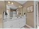 Bright bathroom with a double sink vanity, framed mirror and elegant lighting fixtures at 106 Contender Dr, Clayton, NC 27520