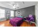 Cozy bedroom features hardwood floors, a ceiling fan, and ample natural light from the window at 106 Contender Dr, Clayton, NC 27520