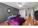 Bedroom boasts hardwood floors, an accent wall with a stylish mirror, and a closet for storage at 106 Contender Dr, Clayton, NC 27520
