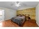 Bedroom features wood floors, a wood accent wall, and a ceiling fan at 106 Contender Dr, Clayton, NC 27520