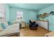 Bright bedroom with daybed, seating, kitchenette, and wood flooring at 106 Contender Dr, Clayton, NC 27520