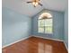 Cozy bedroom featuring hardwood floors, a ceiling fan, and a large window at 106 Contender Dr, Clayton, NC 27520