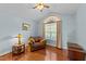 Bedroom with vaulted ceiling, arched window, sitting chair, and hardwood floors at 106 Contender Dr, Clayton, NC 27520