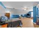 Bonus room with bed, television, ceiling fan, and wood laminate flooring at 106 Contender Dr, Clayton, NC 27520