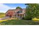 Charming home featuring manicured lawn, mature trees, and a welcoming front porch with a bright yellow door at 106 Contender Dr, Clayton, NC 27520