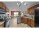 Spacious kitchen with stainless appliances, granite countertops, and an open view of the breakfast area at 106 Contender Dr, Clayton, NC 27520