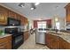 Well-equipped kitchen boasting stainless steel appliances, granite countertops, and wooden cabinetry at 106 Contender Dr, Clayton, NC 27520