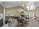 Open living room boasts vaulted ceiling, a fireplace, comfortable seating, carpet flooring and lots of natural light at 106 Contender Dr, Clayton, NC 27520