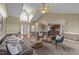 Inviting living room featuring vaulted ceilings, plush seating, and an open layout to the kitchen at 106 Contender Dr, Clayton, NC 27520